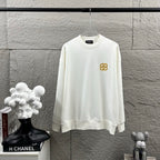 White long-sleeve sweatshirt with crew neck and small gold Balenciaga monogram chest
