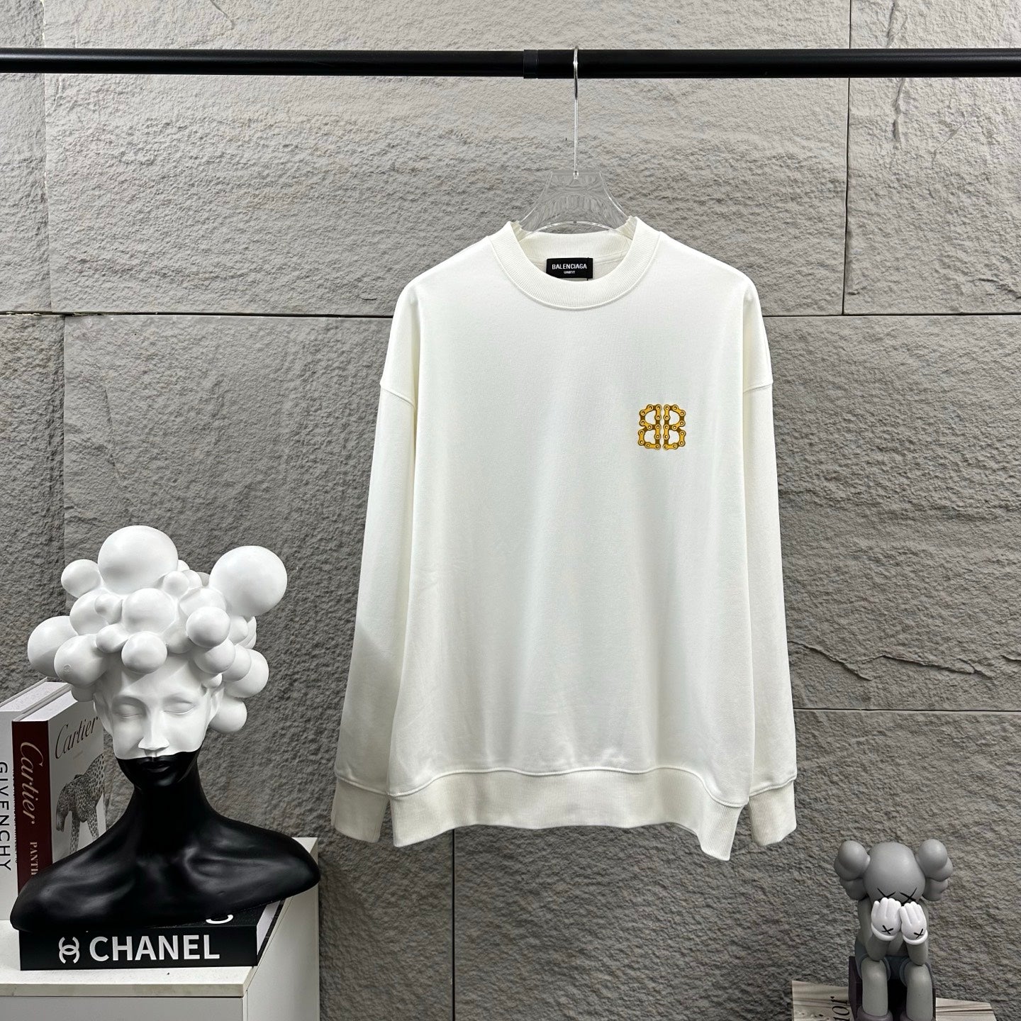 White long-sleeve sweatshirt with crew neck and small gold Balenciaga monogram chest