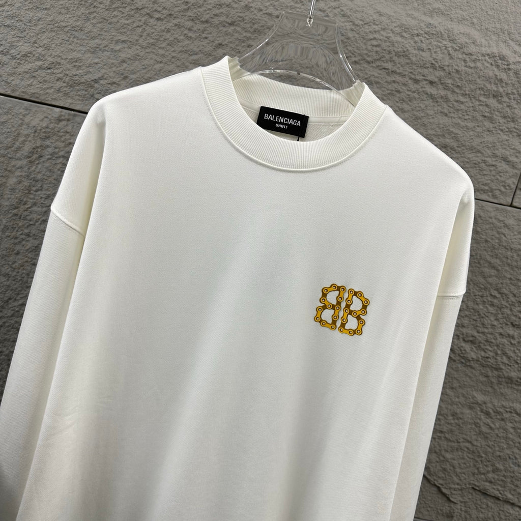 White crew-neck sweatshirt with gold Balenciaga monogram chest emblem