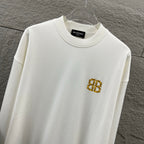 White crew-neck sweatshirt with gold Balenciaga monogram chest emblem