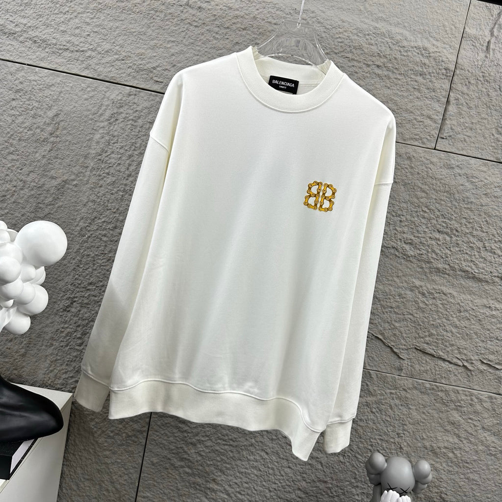 White crew-neck sweatshirt with gold monogram logo on the chest