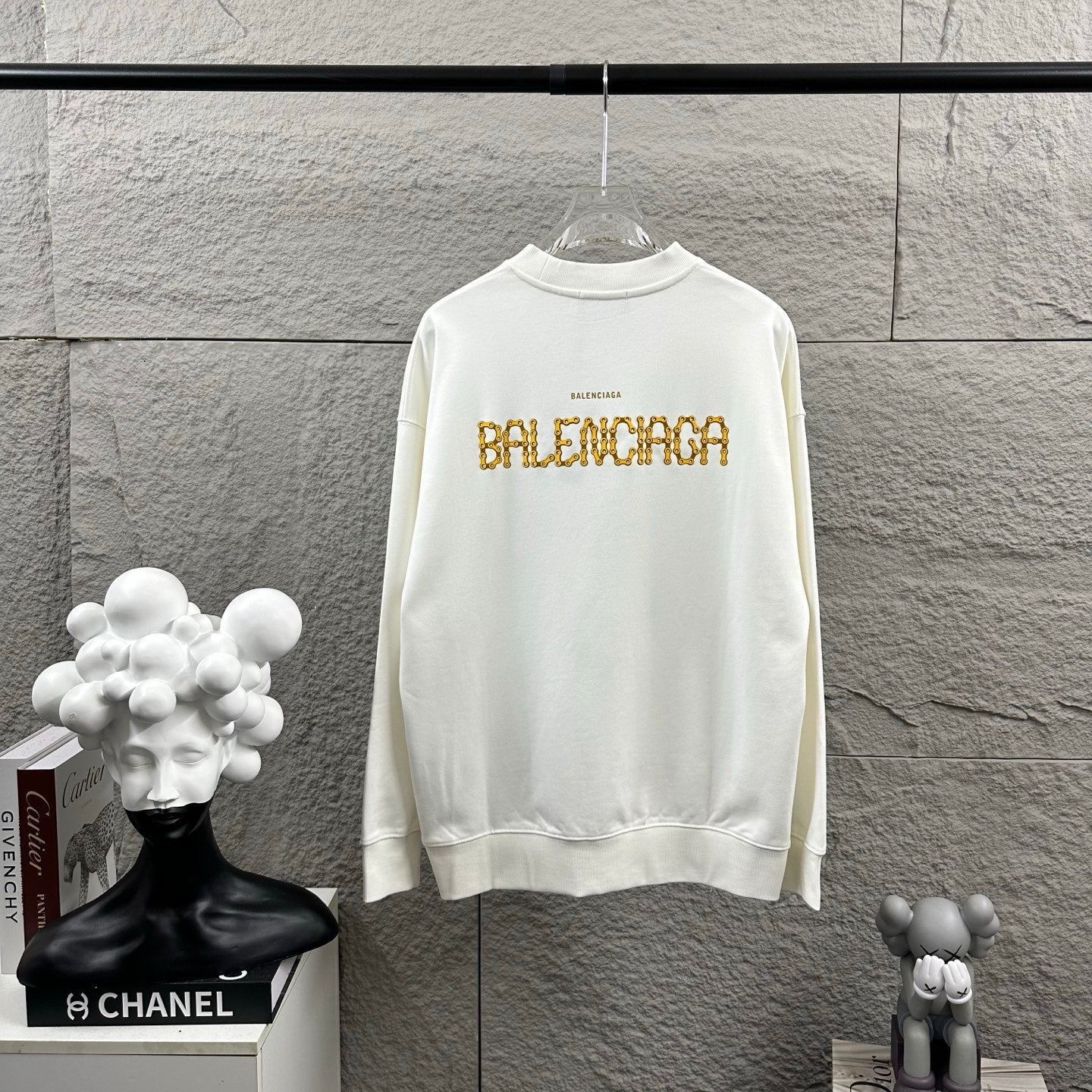 White long-sleeve sweatshirt with crew neck and gold Balenciaga lettering print