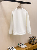 Back view of white crewneck sweatshirt hanging on a rack.