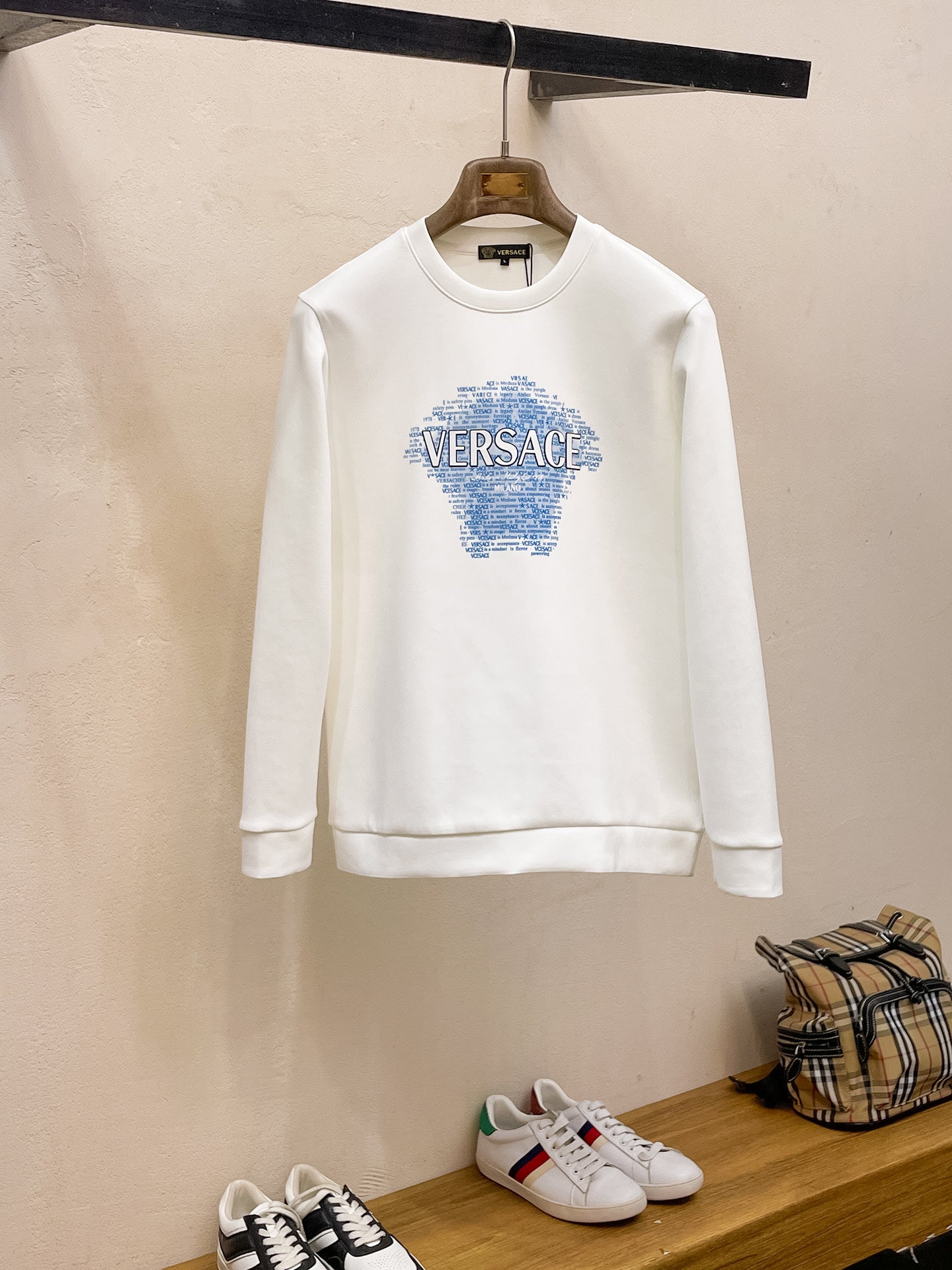 Crewneck sweatshirt in white with Versace blue graphic logo on chest.