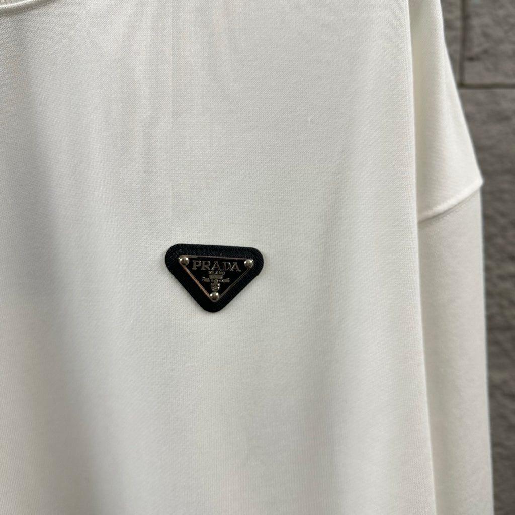 Off-white Prada sweatshirt with black triangular logo patch near the chest.