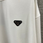 Off-white Prada sweatshirt with black triangular logo patch near the chest.