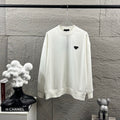 Off-white Prada long-sleeve sweatshirt with black triangular logo patch at chest.