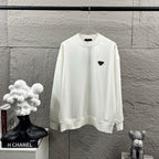 Off-white Prada long-sleeve sweatshirt with black triangular logo patch at chest.