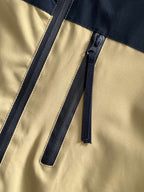 Windbreaker jacket front zipper with adjustable drawstring tabs on navy and light yellow