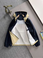 Hooded windbreaker jacket front view in navy with light yellow panels and zip closure