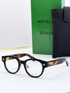 Bottega Veneta black round eyeglasses with tortoise-pattern temples and metal hinges