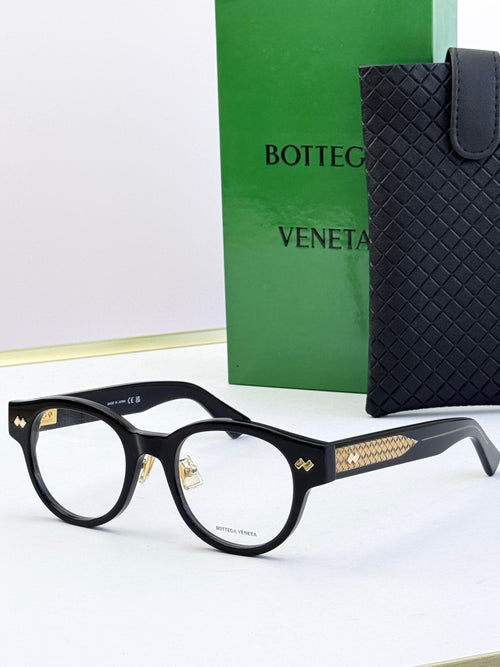 Bottega Veneta black round eyeglasses with gold patterned temples and metal hinges