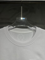 White long-sleeve T-shirt neckline and chest area with subtle circular logo print.