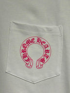 White long-sleeve T-shirt chest pocket with red-pink circular logo graphic.