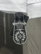 Long-sleeve T-shirt with neck label and brand hangtag attached.