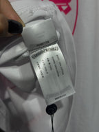 White long-sleeve shirt care label with string attachment