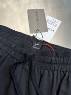 Dark navy drawstring pants with elastic waistband and embroidered logo on front