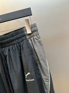 Dark navy pants close-up with elastic waistband and logo patch on the side
