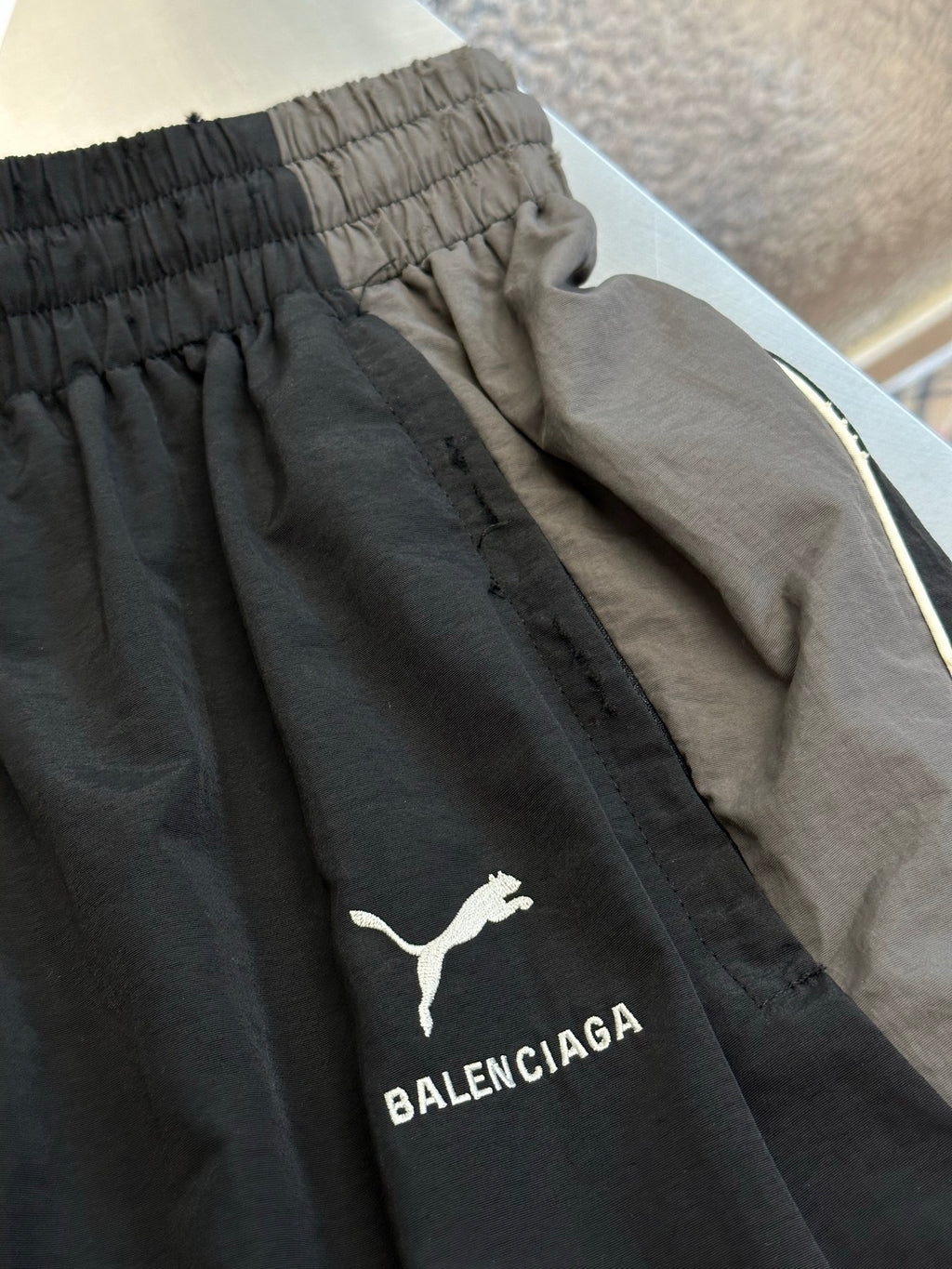 Dark navy pants with embroidered logo on side and contrast inner piping trim