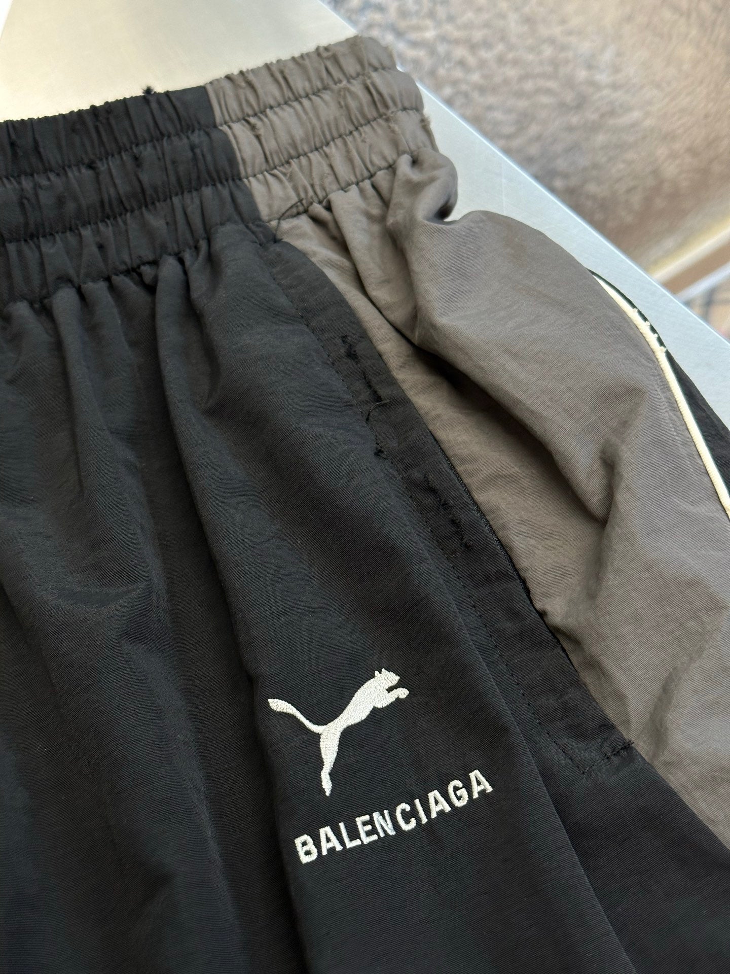 Dark navy pants with embroidered logo on side and contrast inner piping trim
