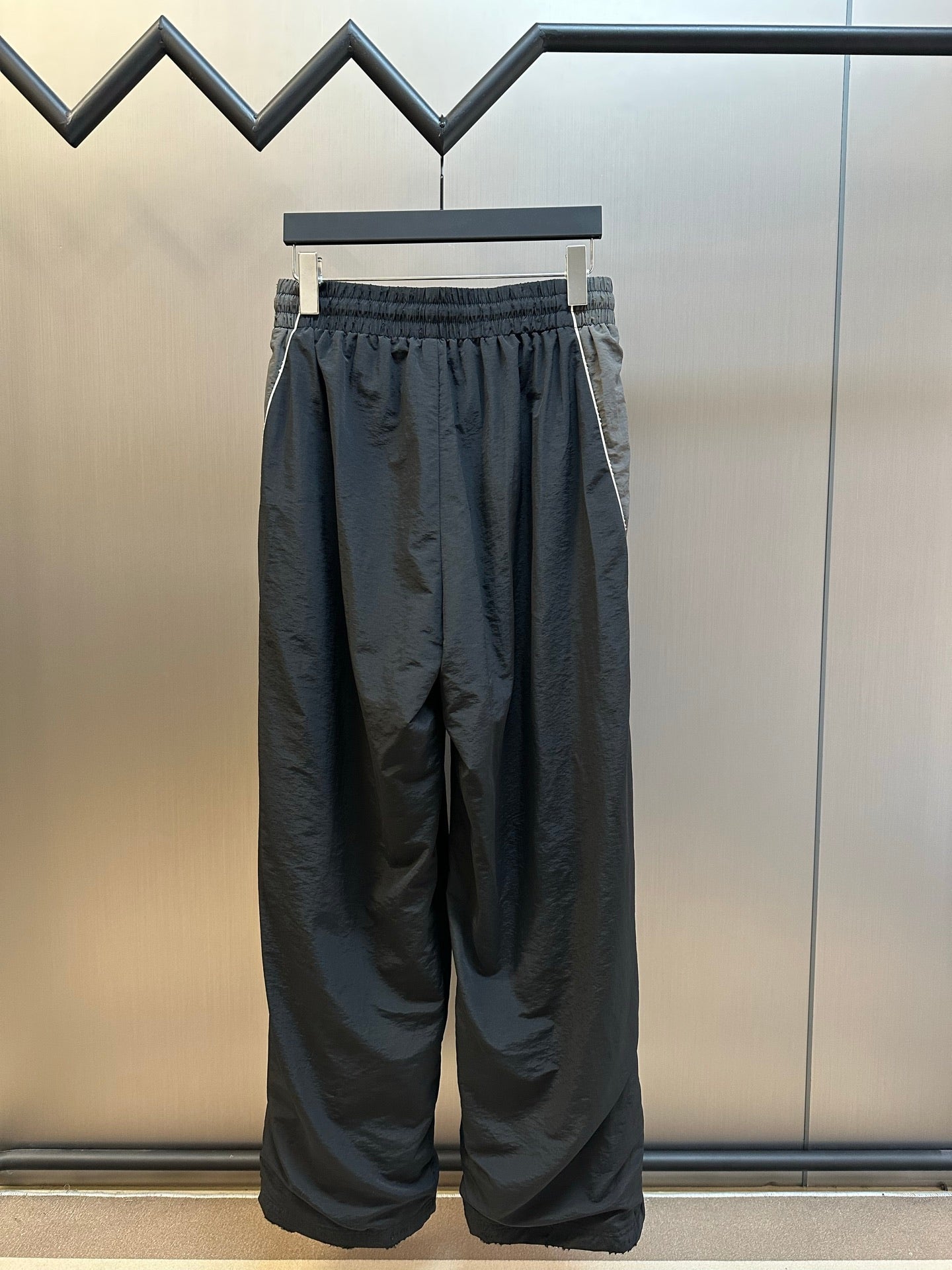 Dark navy wide-leg pants with elastic waist and gathered drape at the thighs
