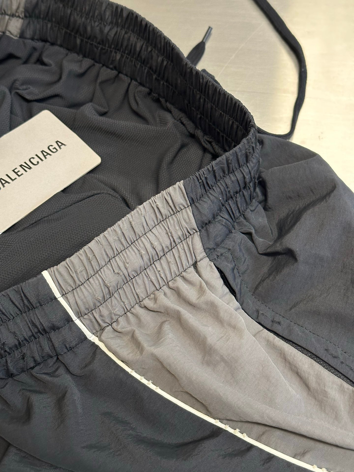 Dark navy pants with elastic waistband and contrast inner panel detail