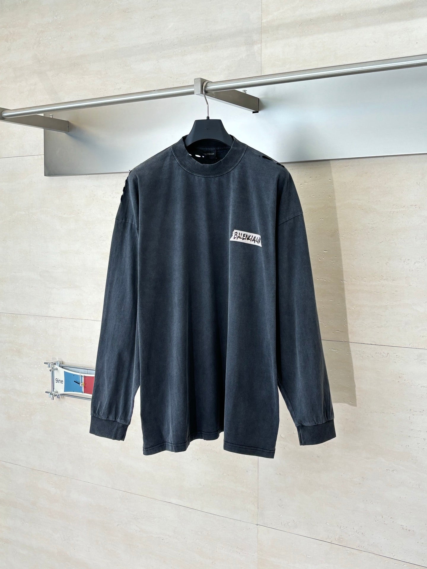 Balenciaga long-sleeve top, dark navy crew neck with small chest logo patch
