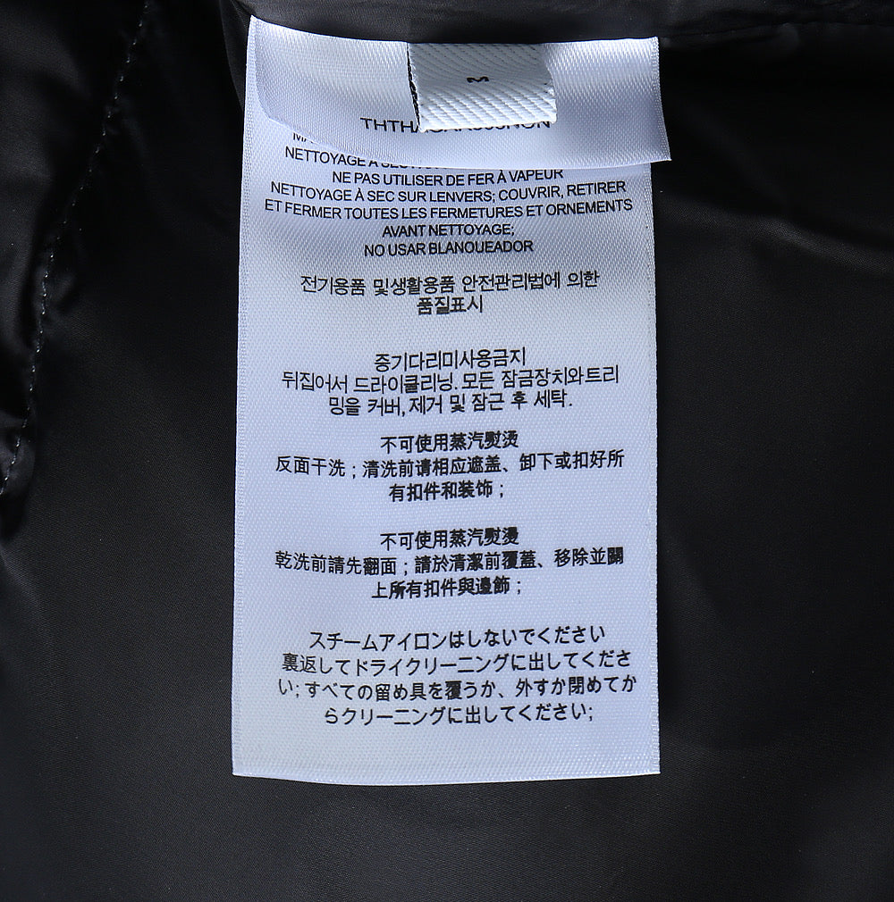Burberry long jacket care label tag on inner collar, white label with text
