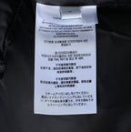 Burberry long jacket care label tag on inner collar, white label with text