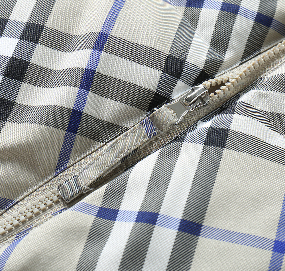 Burberry jacket zipper and stitched edge on blue, black, and white plaid fabric