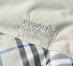 Burberry logo embroidery on jacket lining above a blue and black plaid section
