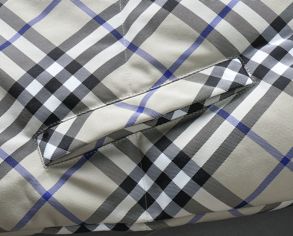 Burberry jacket fabric detail with blue, black, and white plaid pattern