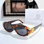 Versace sunglasses with dark lenses, tortoiseshell frame, and gold logo detail on the temple