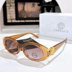 Versace sunglasses with dark lenses, amber frame, and gold logo detail on the temple