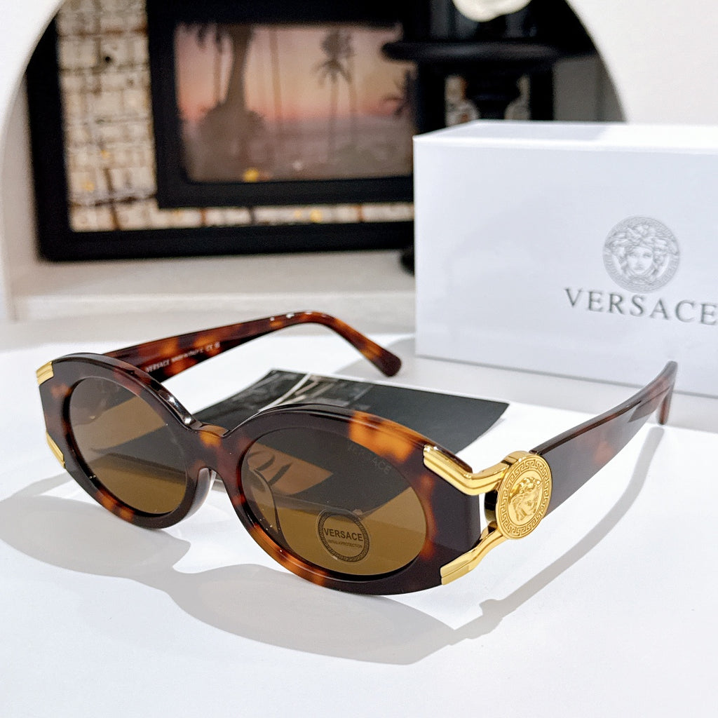 Versace sunglasses with dark lenses, tortoiseshell frame, and gold logo detail on the temple