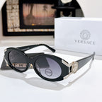 Versace sunglasses with dark lenses, black frame, and gold logo detail on the temple