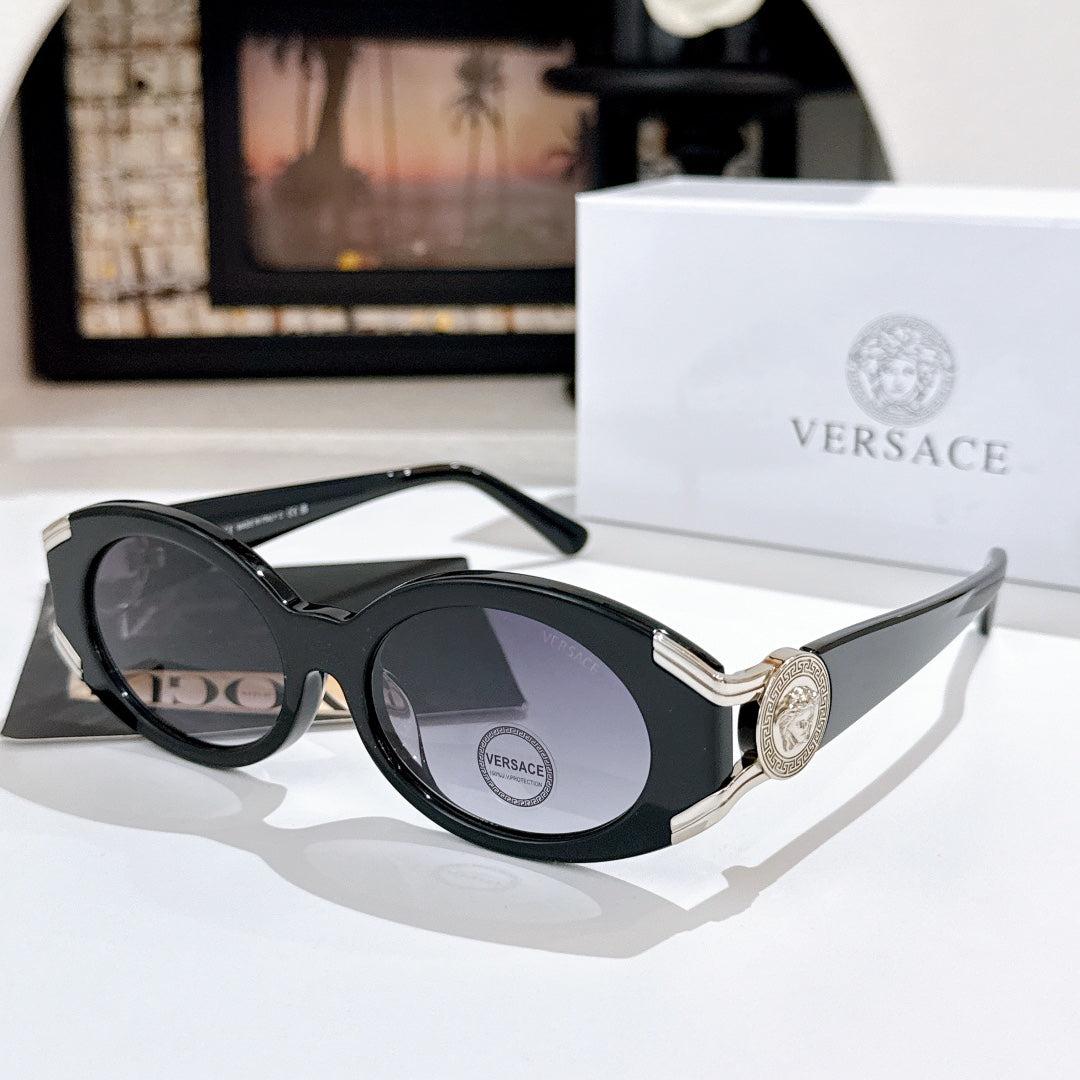 Versace sunglasses with dark lenses, black frame, and gold logo detail on the temple