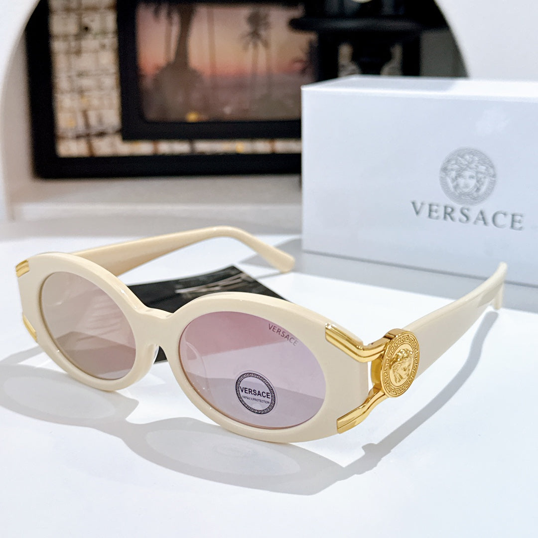 Versace sunglasses with light lenses, cream frame, and gold logo detail on the temple