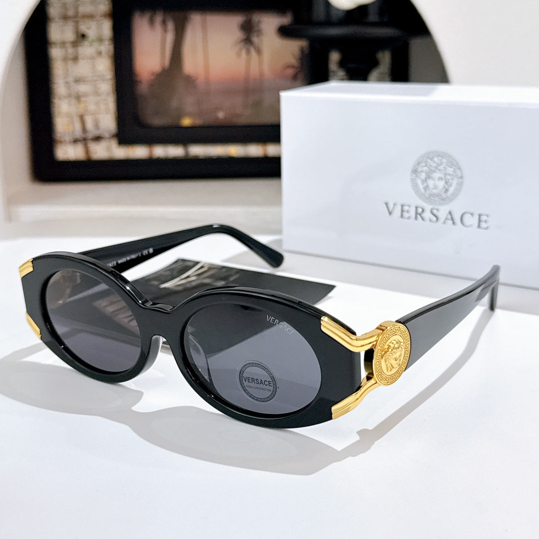 Versace sunglasses with dark lenses, black frame, and gold logo detail on the temple
