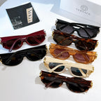 Assorted Versace sunglasses with dark lenses in black, brown, red, and cream frames