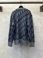 Dior long-sleeve knit sweater in blue and black with allover logo pattern, gray hem