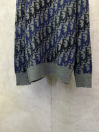 Dior long-sleeve knit sweater with blue-and-black logo pattern and gray bottom hem