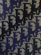 Dior knit fabric close-up with blue and black repeated logo pattern