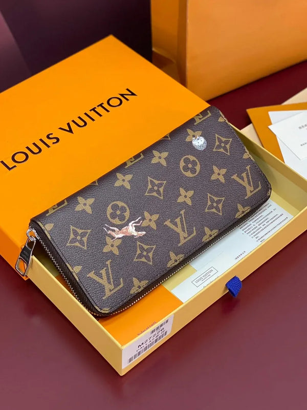 Louis Vuitton monogram zip wallet with brown canvas and gold-tone hardware, flat lay.