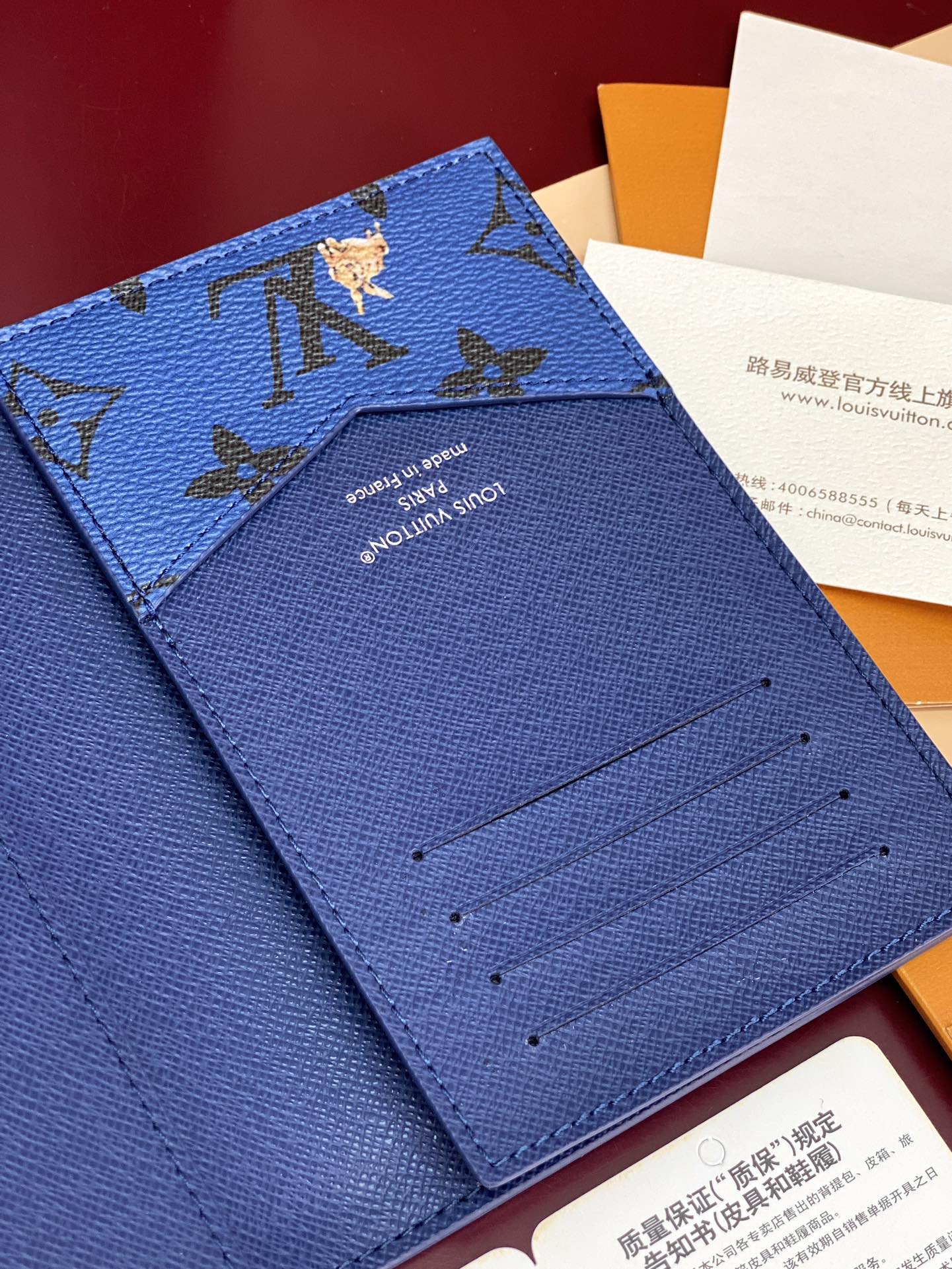 Blue Louis Vuitton small bag interior with card slots and branding on lining