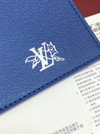 Blue Louis Vuitton small bag close-up of LV emblem with stitching along edge