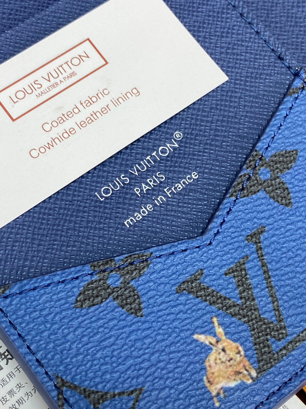 Blue Louis Vuitton small bag corner close-up with made in France text and seam