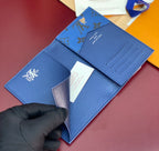 Blue Louis Vuitton small bag with logo emblem and fold-over flap