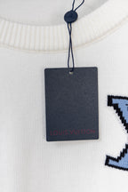 White sweater neckline with dangling hang tag and blue logo part