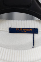 Neck tag on white knit sweater with “LOUIS VUITTON PARIS” label